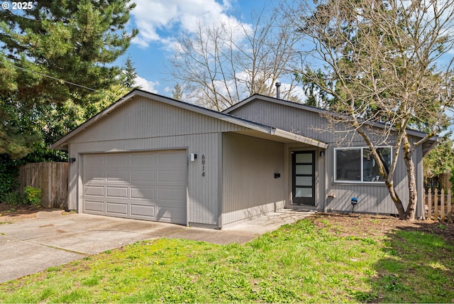 view of front of home with concrete driveway and a garage
