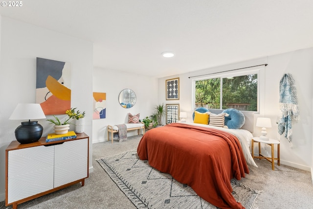 bedroom with carpet floors and baseboards
