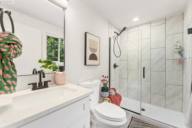 bathroom featuring a stall shower, toilet, vanity, and recessed lighting