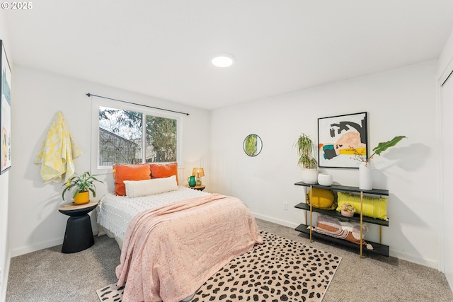 bedroom with carpet floors and baseboards
