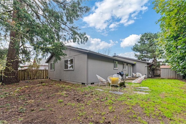 rear view of property featuring fence