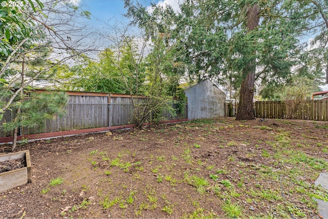 fenced backyard featuring a shed and an outbuilding