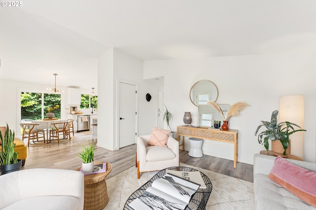 living room featuring light wood finished floors and vaulted ceiling