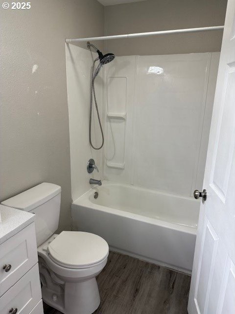 767 32nd Ave, Longview, WA 98632 - bathroom with toilet, wood finished floors, vanity, and bathing tub / shower combination