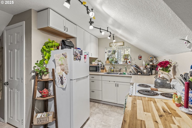 767 32nd Ave, Longview, WA 98632 - kitchen featuring white appliances, a sink, a textured ceiling, white cabinetry, and wooden counters