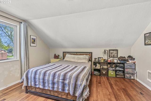 767 32nd Ave, Longview, WA 98632 - bedroom with lofted ceiling, wood finished floors, baseboards, and a textured ceiling