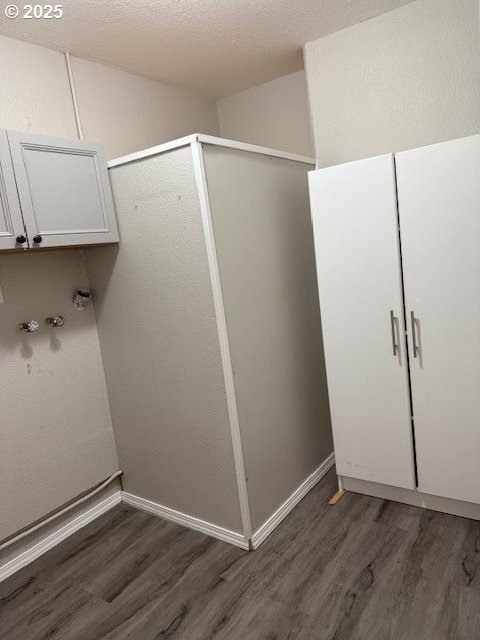 767 32nd Ave, Longview, WA 98632 - laundry area with wood finished floors and baseboards