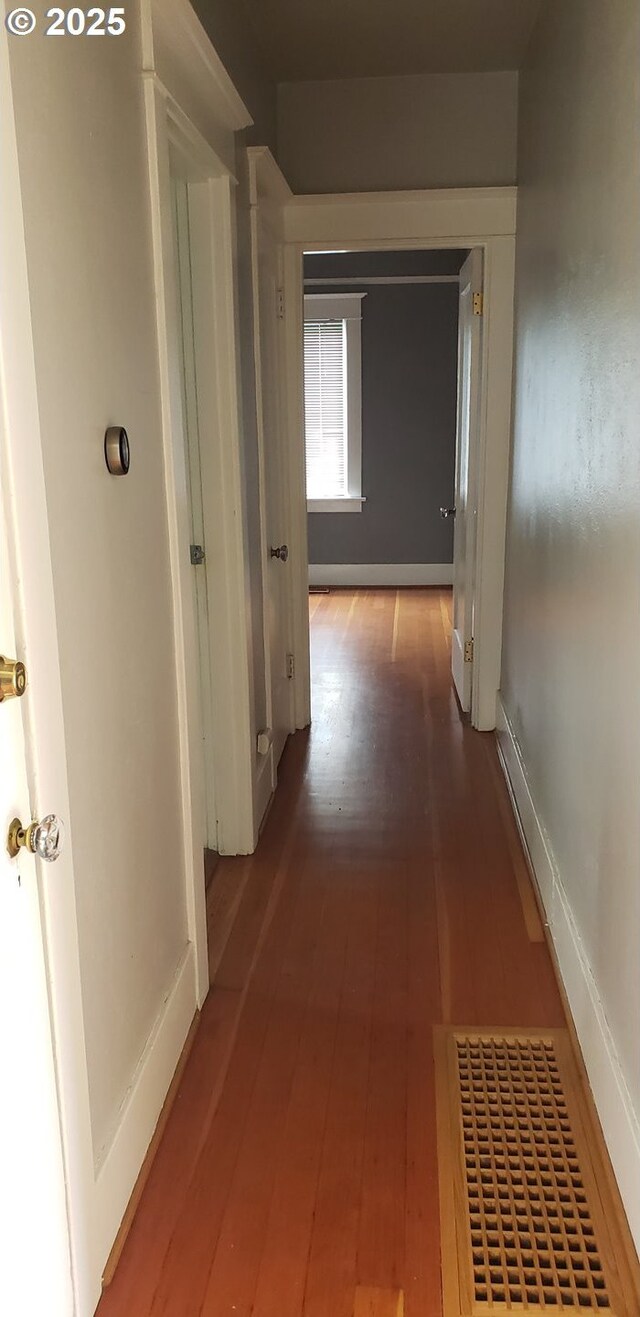 hall with hardwood / wood-style floors