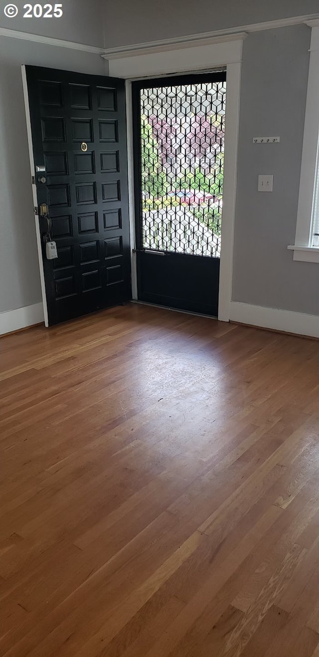 entryway with wood finished floors and baseboards