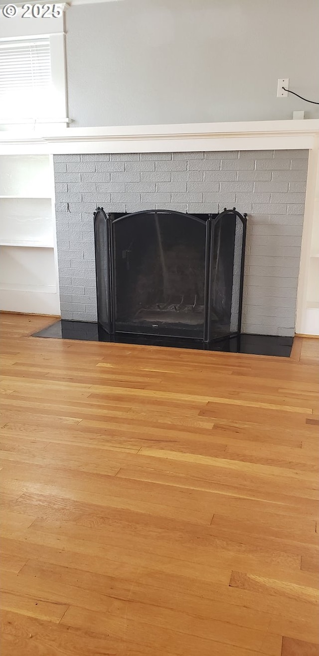 detailed view of wood finished floors and a fireplace