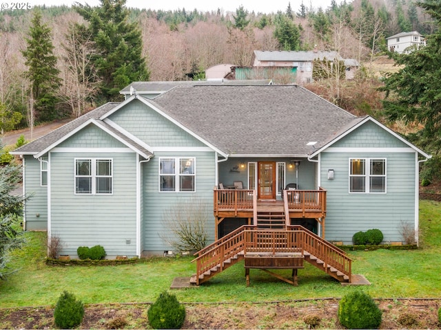 back of house with a lawn and a wooden deck