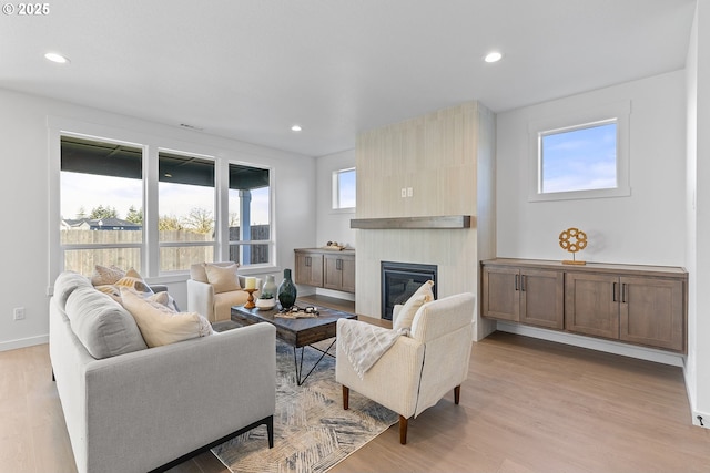 2112 NW 17th Pl, Battle Ground, WA 98604 - living area featuring light wood-style floors, a tile fireplace, and recessed lighting