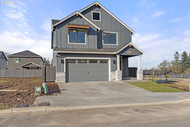2112 NW 17th Pl, Battle Ground, WA 98604 - view of front facade with board and batten siding, a garage, concrete driveway, and stone siding