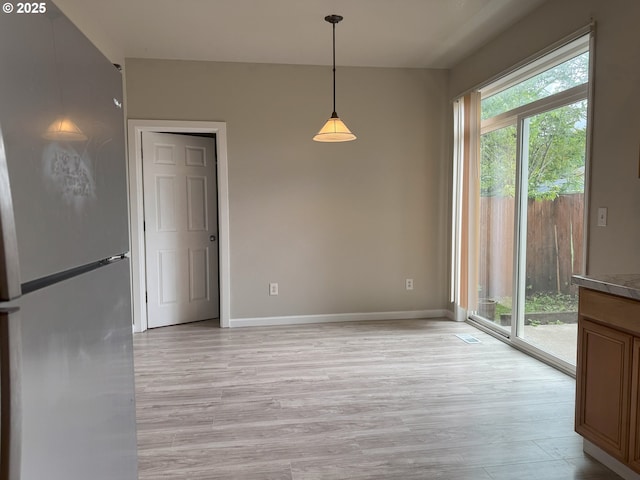 6668 SE 72nd Ave, Portland, OR 97206 - unfurnished dining area featuring light wood finished floors and baseboards