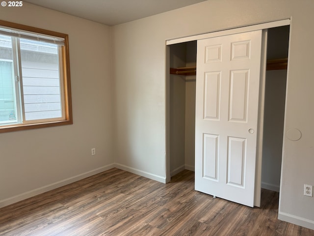 6668 SE 72nd Ave, Portland, OR 97206 - unfurnished bedroom with a closet, dark wood-style flooring, and baseboards