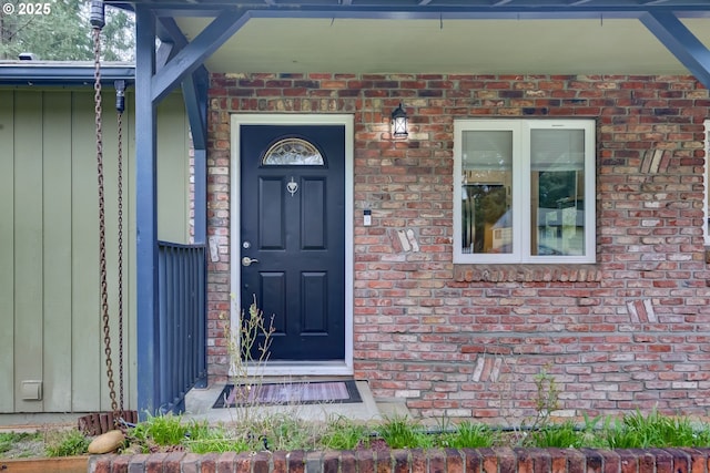 doorway to property with brick siding