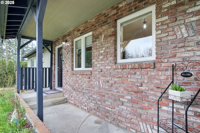 view of property exterior featuring a porch and brick siding