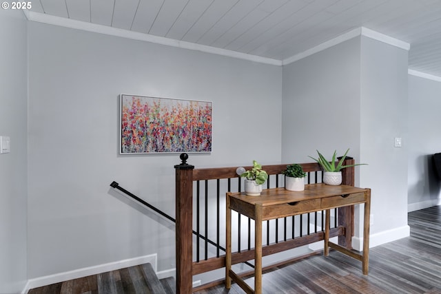 stairs with baseboards, wooden ceiling, wood finished floors, and crown molding