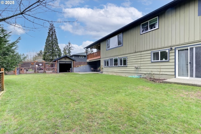 exterior space with a yard, an outdoor structure, and fence