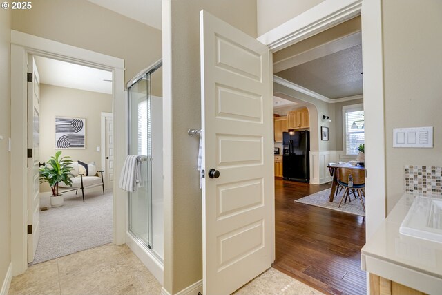 7010 N Kellogg St, Portland, OR 97203 - hallway with arched walkways, ornamental molding, and dark colored carpet