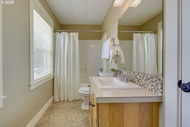 7010 N Kellogg St, Portland, OR 97203 - full bathroom with vanity, healthy amount of natural light, toilet, and baseboards
