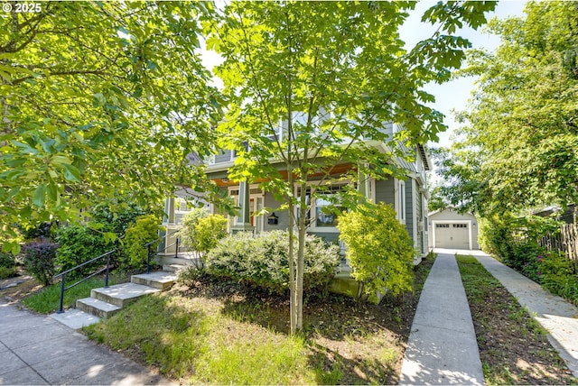 7010 N Kellogg St, Portland, OR 97203 - obstructed view of property with a porch, a detached garage, driveway, and an outdoor structure