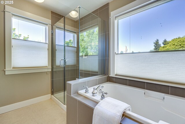 7010 N Kellogg St, Portland, OR 97203 - bathroom with a garden tub, a shower stall, baseboards, and tile patterned floors