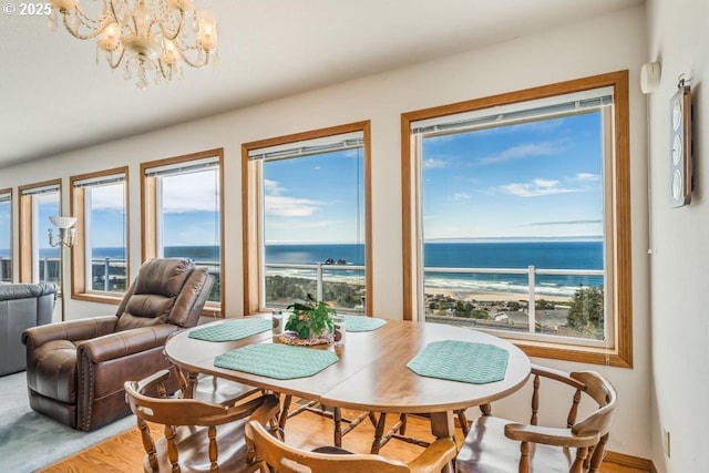 461 Terrace Dr, Rockaway Beach, OR 97136 - dining area with a chandelier, a water view, and wood finished floors