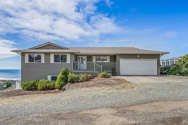 461 Terrace Dr, Rockaway Beach, OR 97136 - ranch-style house with covered porch, a garage, and concrete driveway