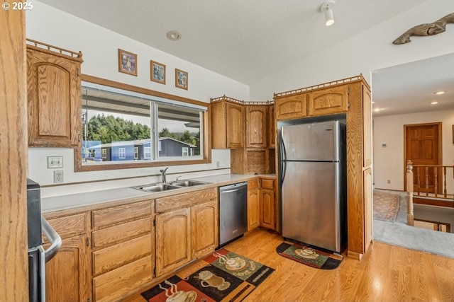 461 Terrace Dr, Rockaway Beach, OR 97136 - kitchen featuring stainless steel appliances, a sink, light countertops, light wood-type flooring, and brown cabinets