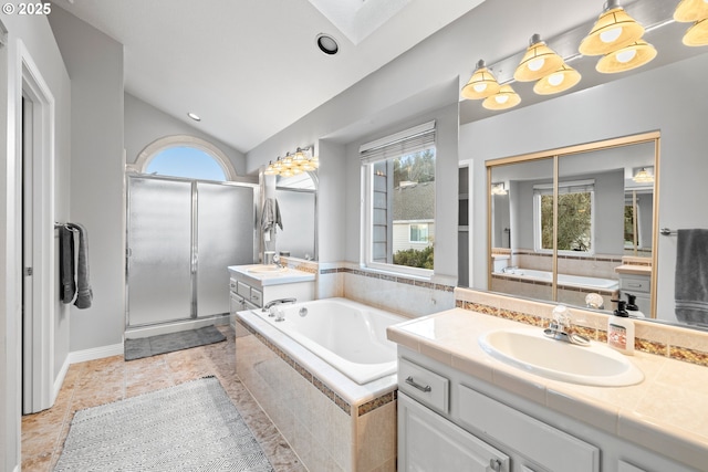 bathroom featuring vanity, lofted ceiling with skylight, and shower with separate bathtub