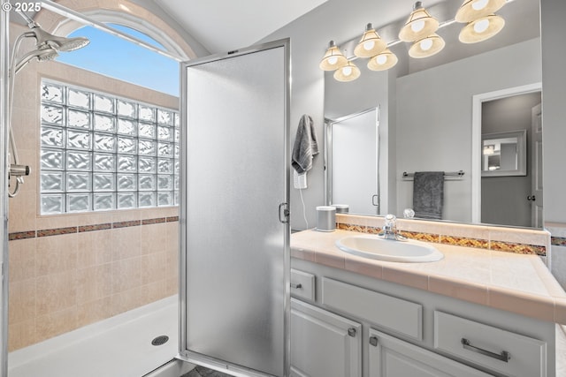 bathroom featuring vanity and an enclosed shower