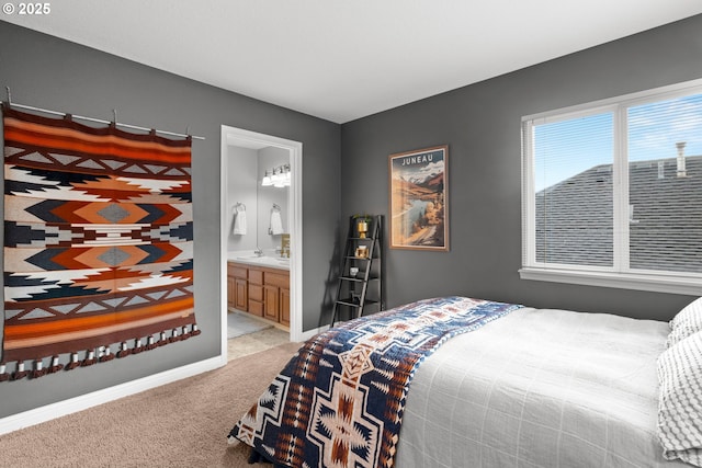 bedroom with light colored carpet and ensuite bath