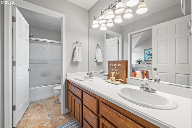 full bathroom with toilet, vanity, and shower / bath combination with glass door