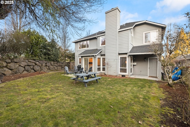 rear view of house featuring a lawn and a patio area