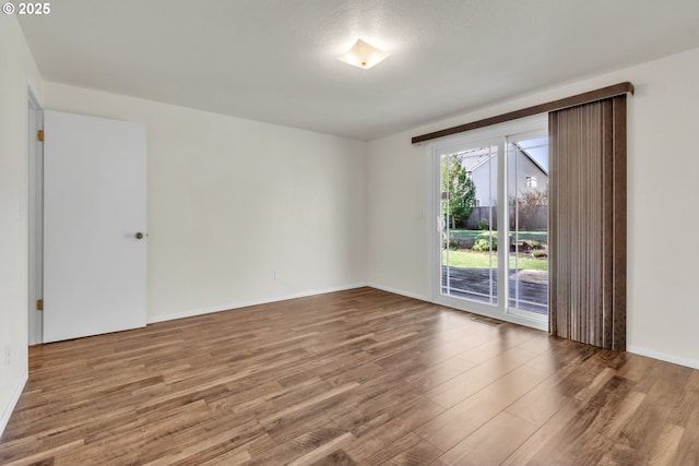 spare room featuring hardwood / wood-style floors