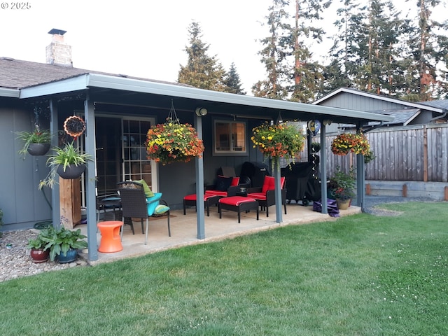 back of property featuring a yard and a patio area