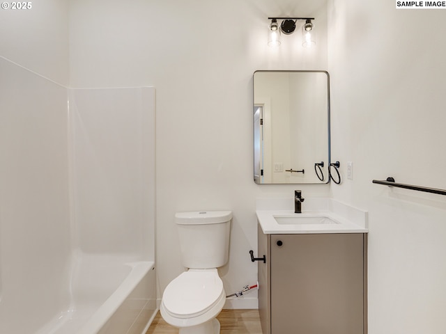 full bathroom with bathtub / shower combination, vanity, toilet, and wood-type flooring