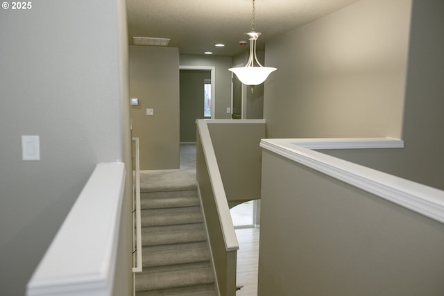 stairs featuring baseboards, visible vents, and recessed lighting