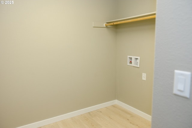 laundry area with hookup for a washing machine, laundry area, light wood-style flooring, and baseboards