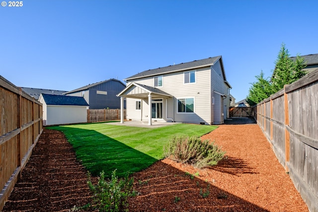 rear view of house featuring a fenced backyard, a patio, and a lawn