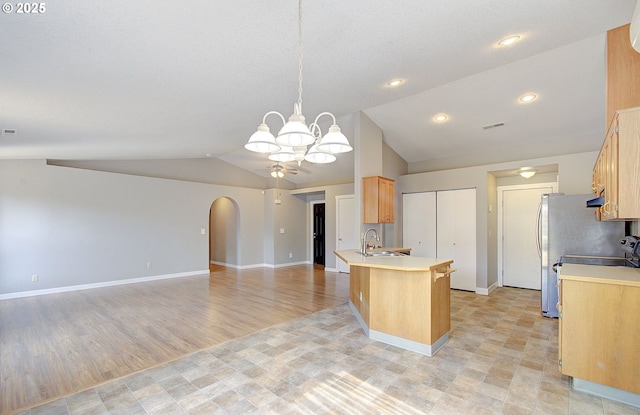 15807 NE 48th Cir, Vancouver, WA 98682 - kitchen featuring lofted ceiling, light countertops, a peninsula, a chandelier, and ceiling fan