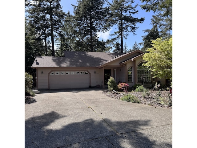 ranch-style home with an attached garage and concrete driveway