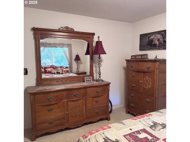 bedroom with baseboards and light carpet