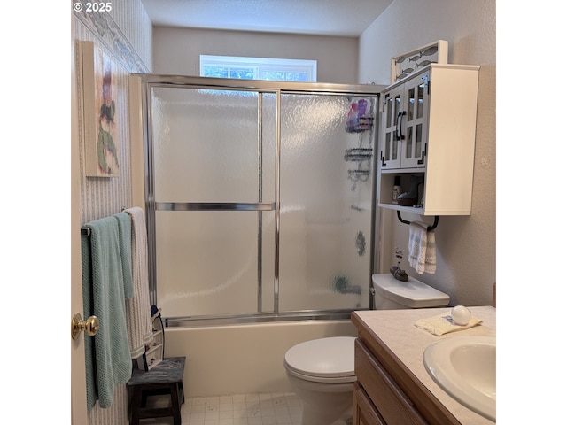 full bath with vanity, enclosed tub / shower combo, and toilet