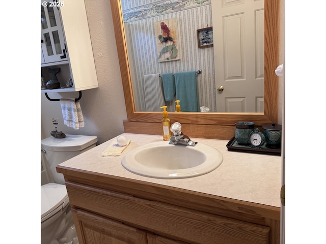 bathroom with toilet and vanity
