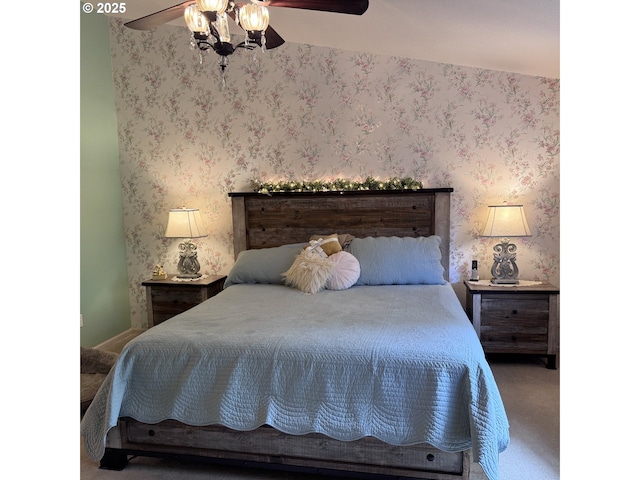 carpeted bedroom with a ceiling fan and wallpapered walls