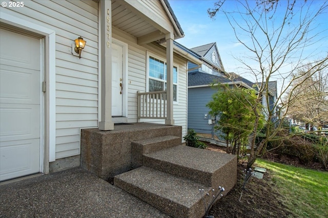 view of exterior entry featuring an attached garage