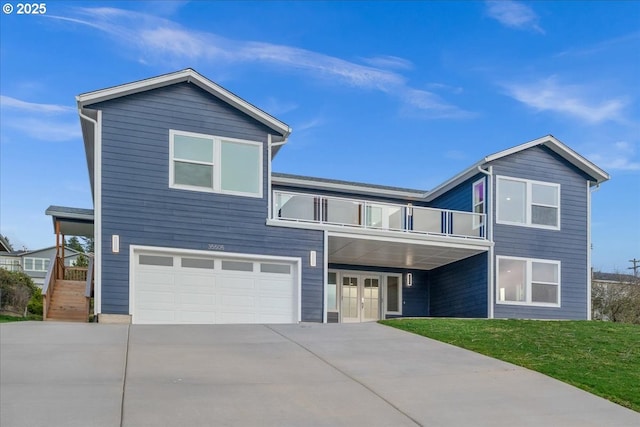 view of front of property featuring driveway, a front lawn, french doors, an attached garage, and a balcony