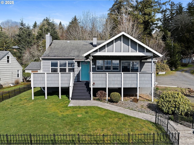 view of front of property featuring board and batten siding, fence, a front yard, a deck, and a sunroom